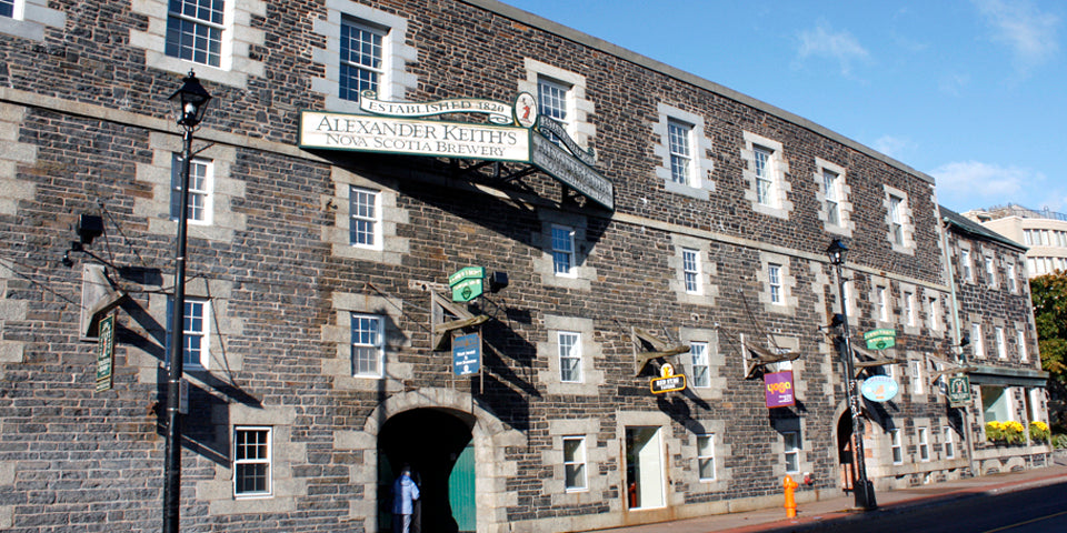 Gray stone building with streetlights and decorative elements on a clear day